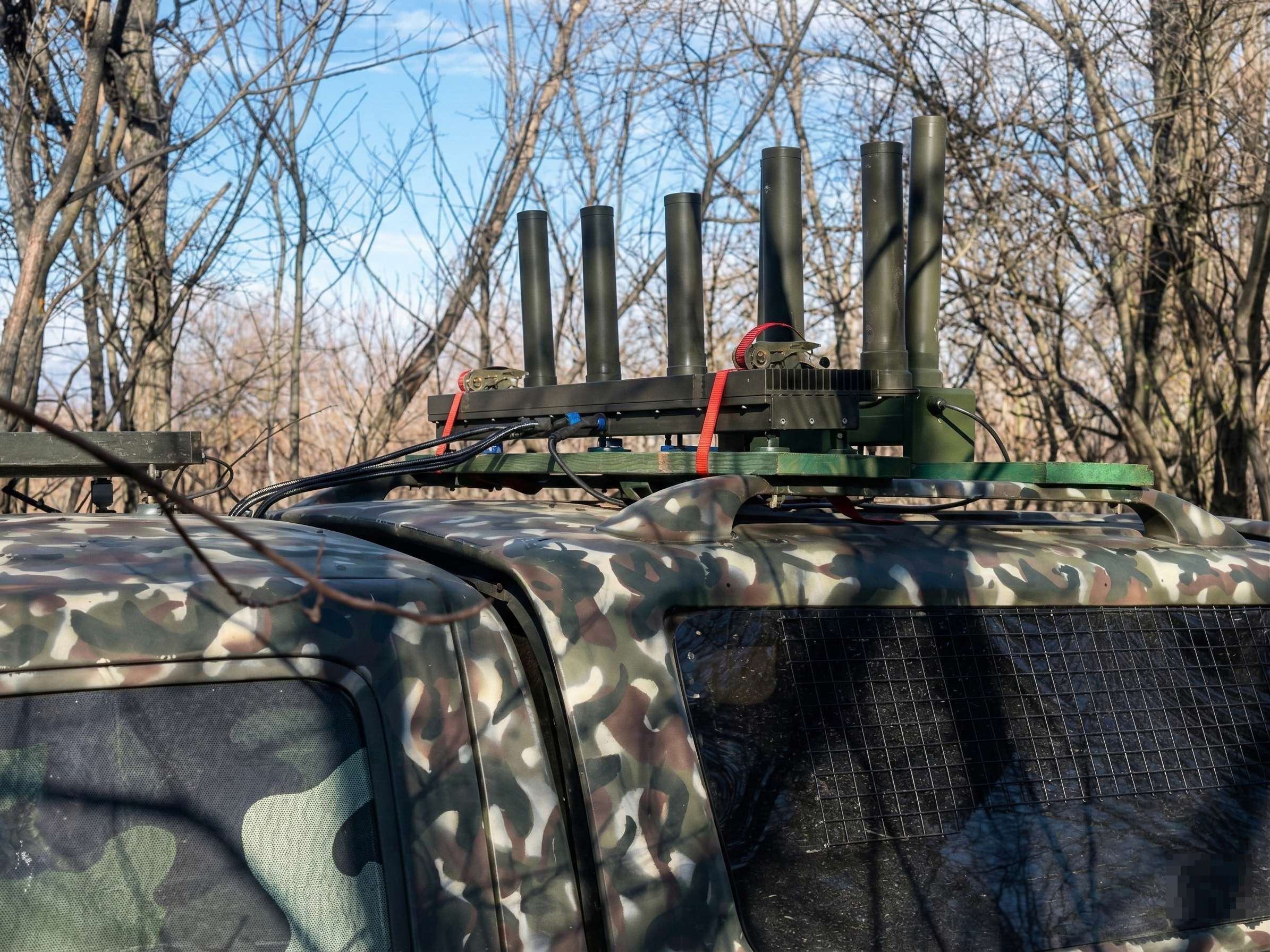 Close-up of Khvylia EW antennas mounted on a camouflage vehicle roof